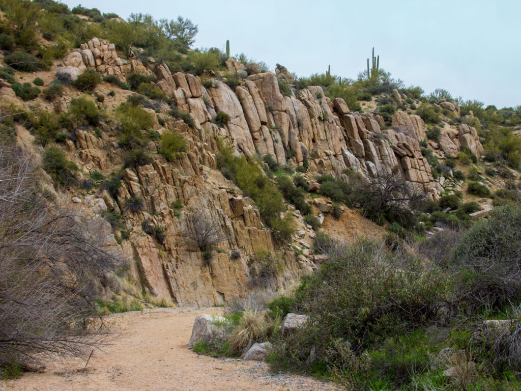 Landscape image the begining of the granite faced wash on the Blue Wash Hiking Trail, near Carefree, Arizona. Rock faces, shrub and Saguaro Cactus in the background, Easy Hiking Trails, Central Arizona, Northern Phoenix Area, Family and Dog Friendly Hiking Trails, Copyright azutopia.com.