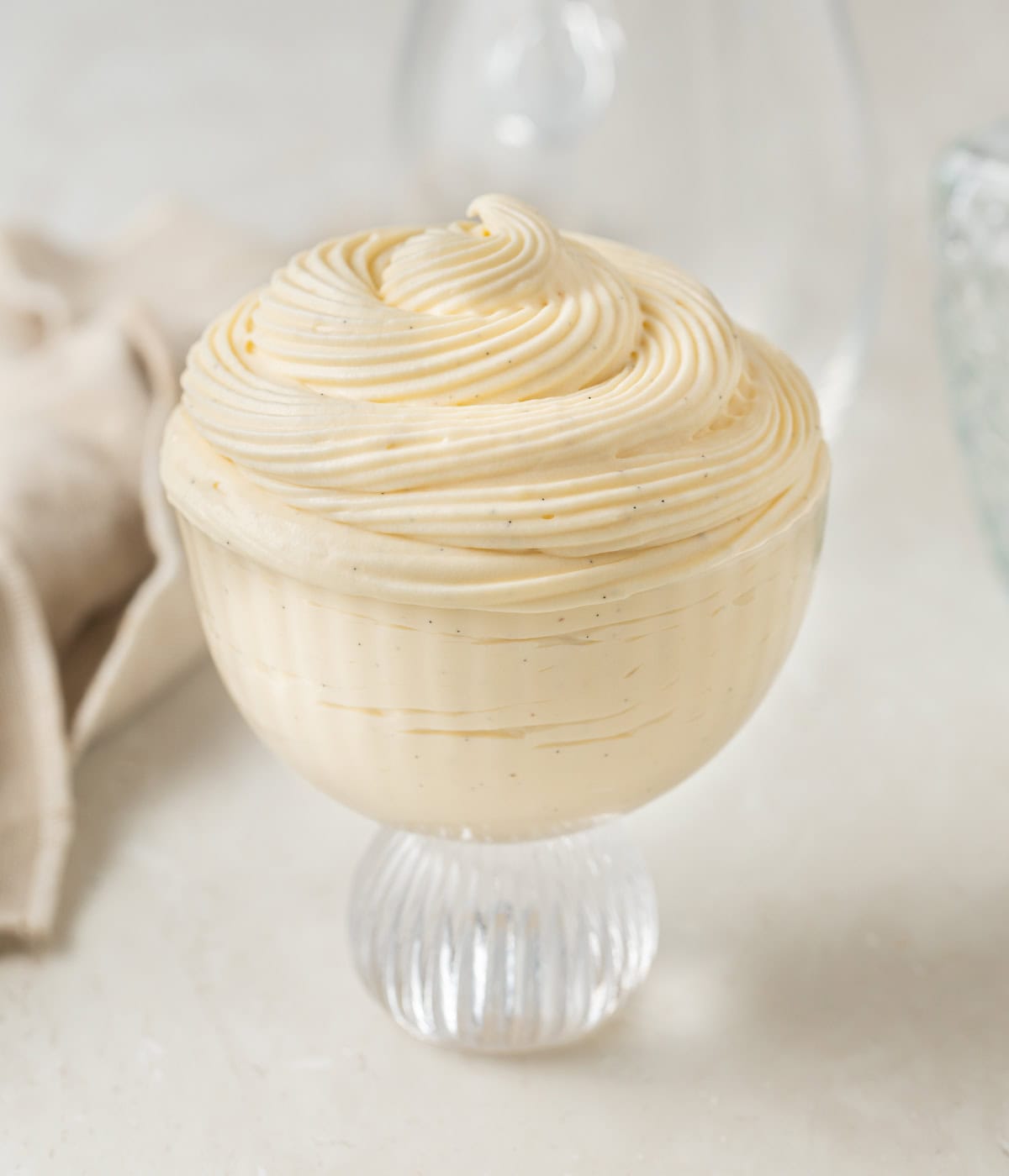 Custard piped inside a glass dessert cup.
