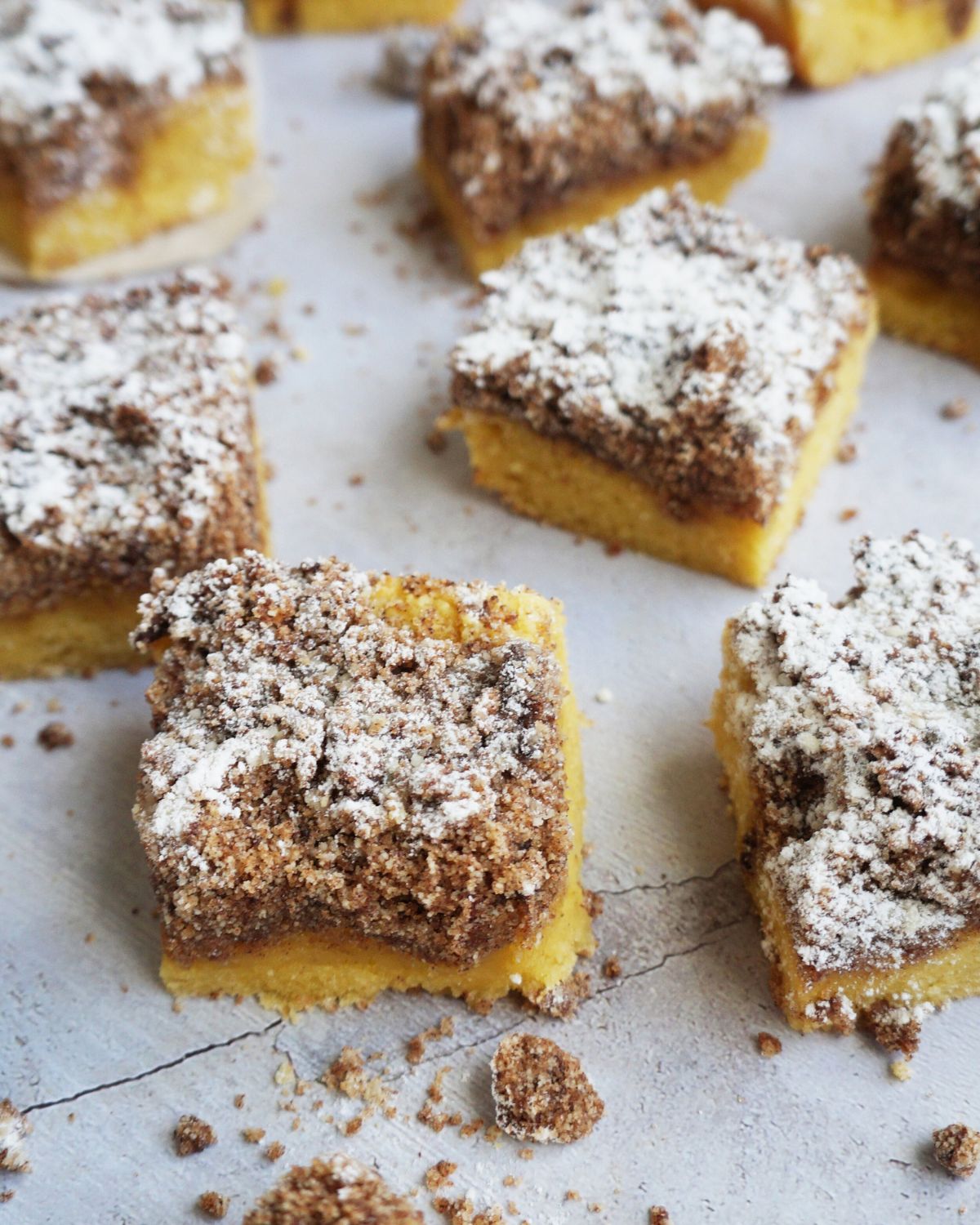 six finished keto coffee cake squares arranged on a counter