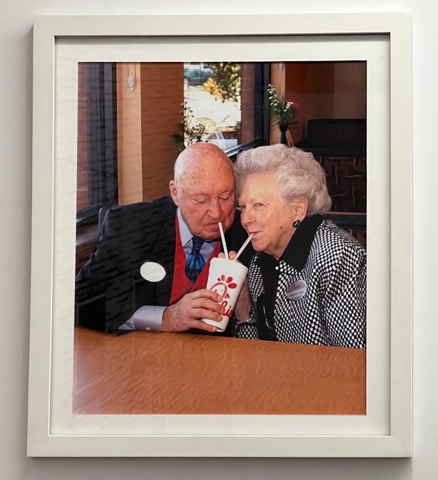 Portrait of two people drinking a soda.