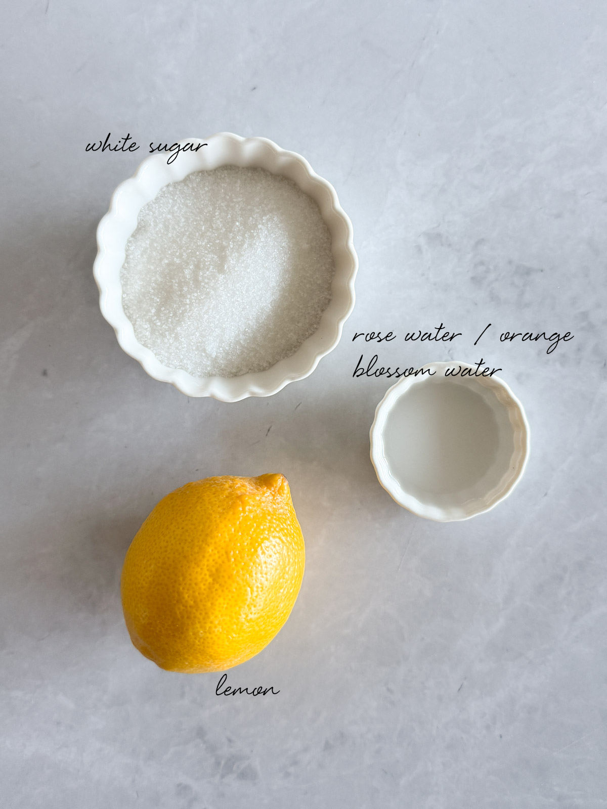 white sugar, lemon and flower blossom water laid out