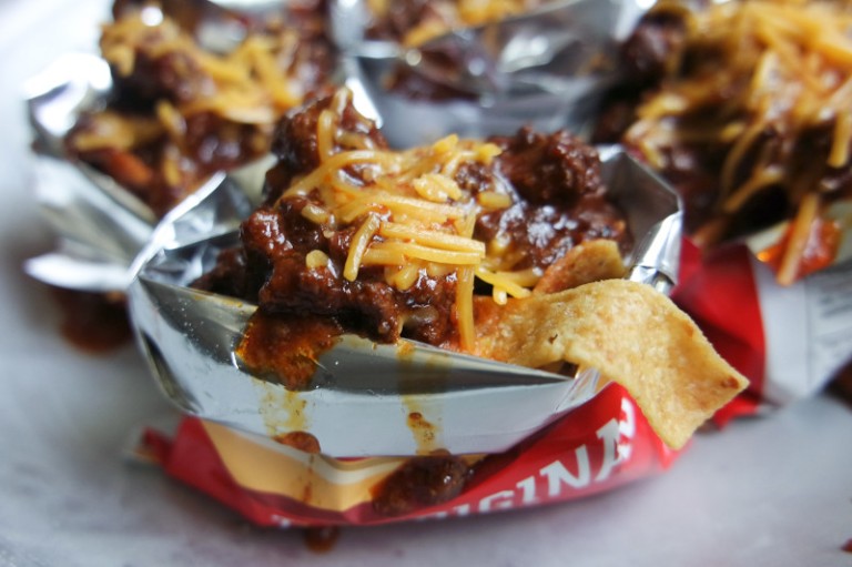 Fritos mixed with beef and cheese in a Fritos bag.