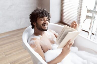 Man indulging in a bubble bath self-care activity