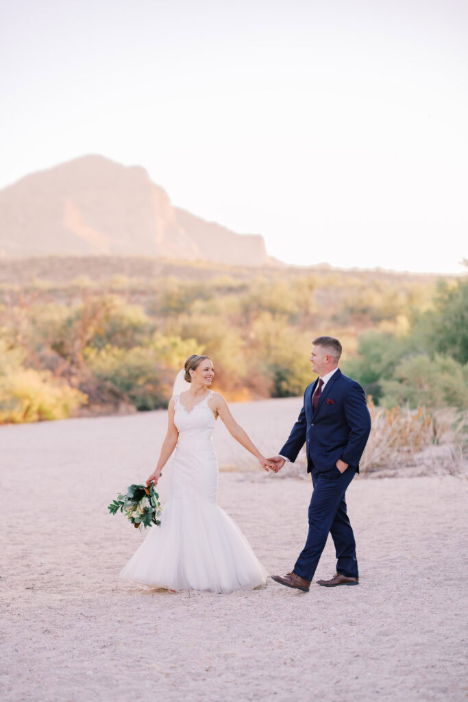 Bride and groom smile at each other after their wedding at Catalina State Park in Tucson, Arizona.