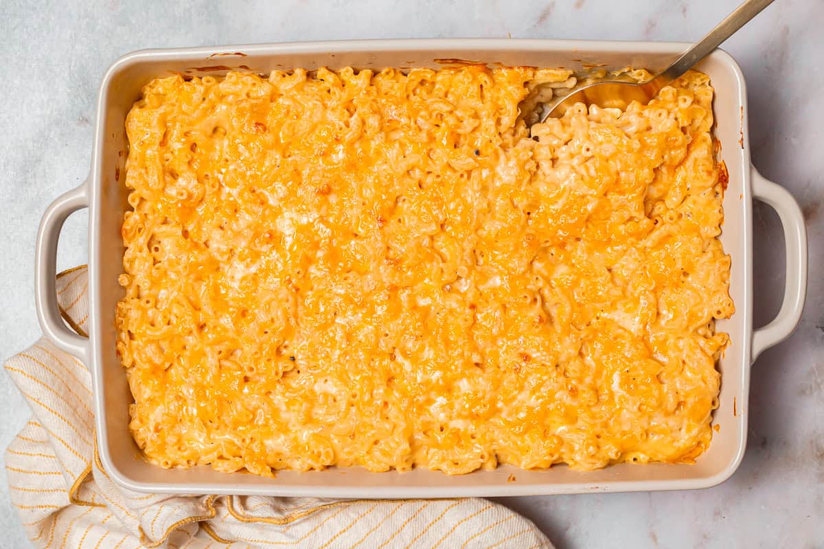 overhead view of chick fil a mac and cheese in a casserole dish with a spoon.