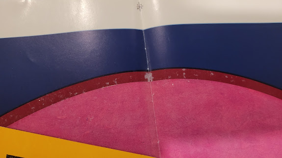 splotches of red ink missing in red border on front of poster