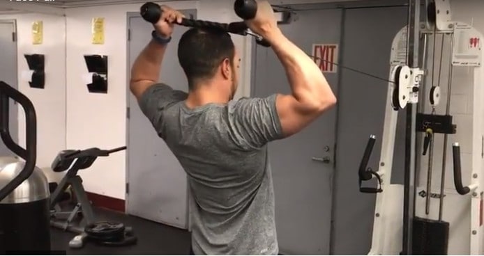 alex doing a face pull on a cable machine to isolate the rear delts