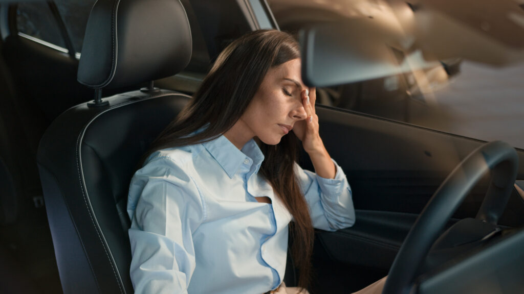 Exhausted woman in her car during a breaking point in women’s burnout recovery