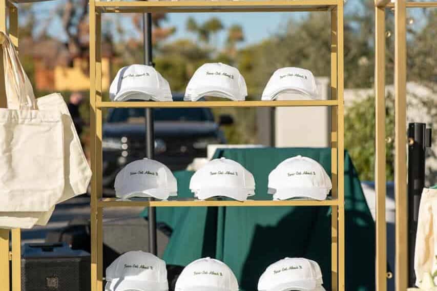 Event Photography for an Unforgettable First Birthday 10 Rack that has custom hats on it at a one year olds birthday party.