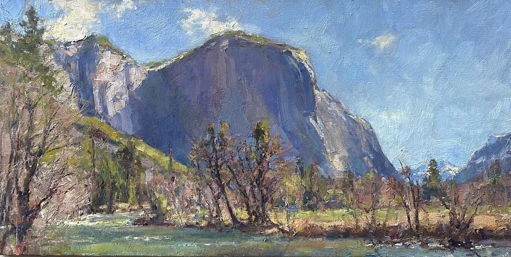 A mountain with trees in the background  Description automatically generated