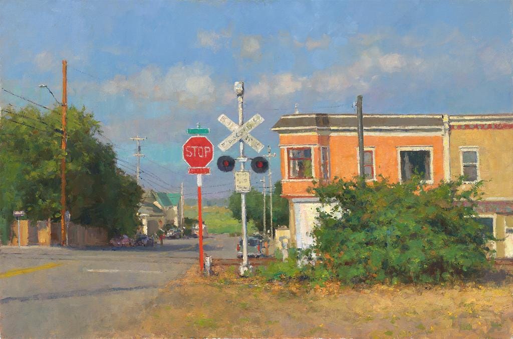 A street sign and a stop sign  Description automatically generated with medium confidence