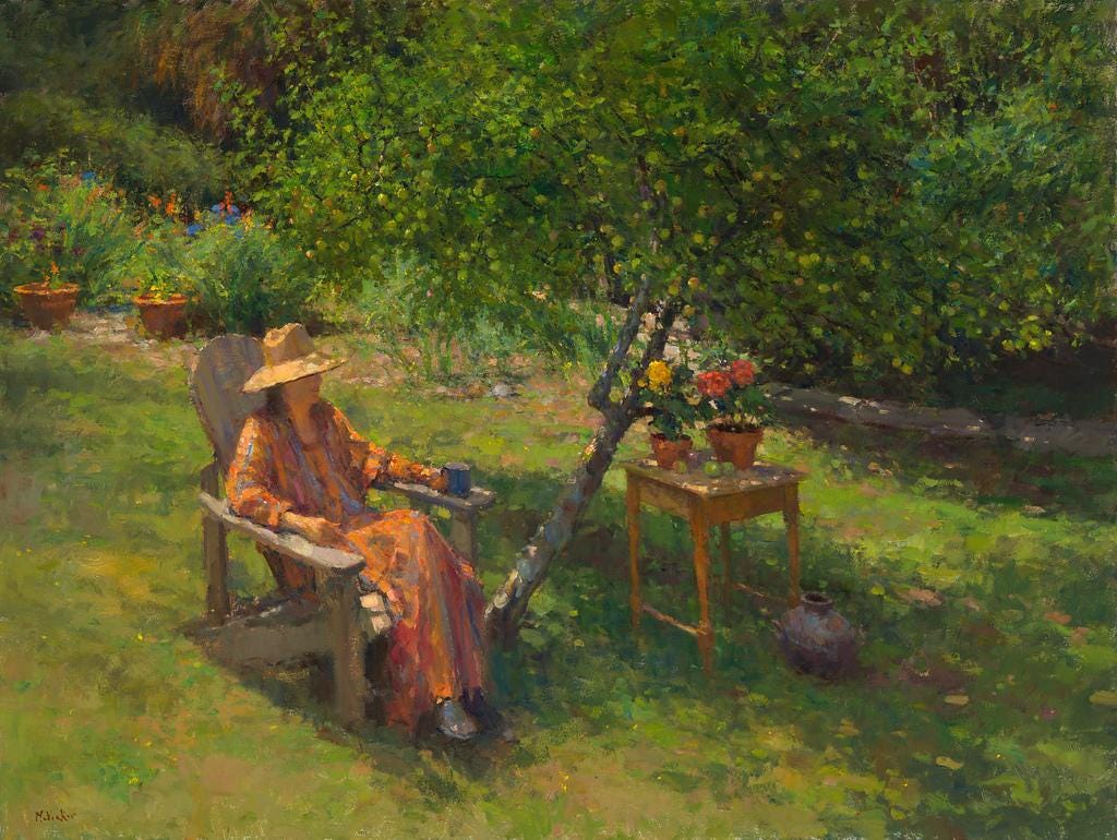A person sitting in a chair in a garden  Description automatically generated