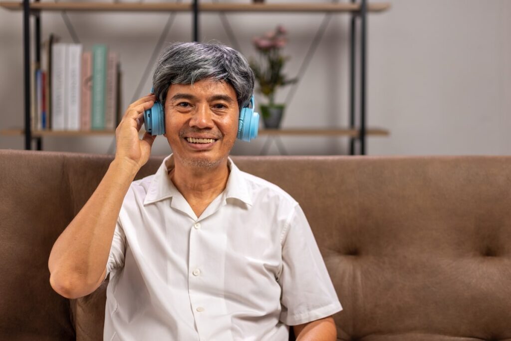 A smiling older man with headphones