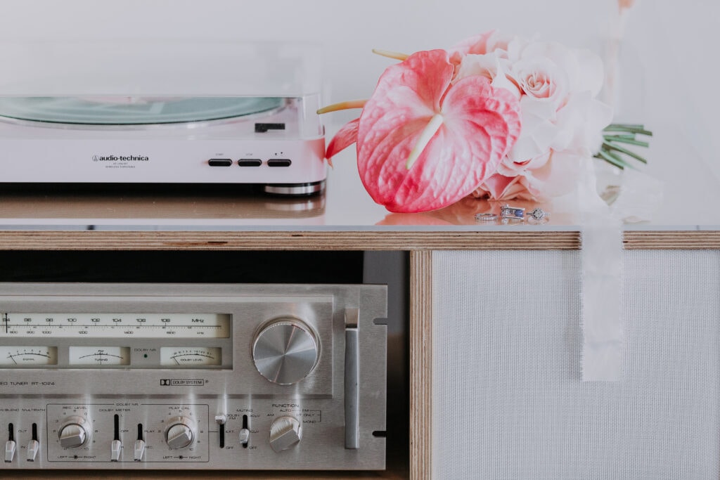 A close-up photo of a bright pink bouquet sitting on top of a vintage record player at Sure Thing Chapel in Las Vegas.
